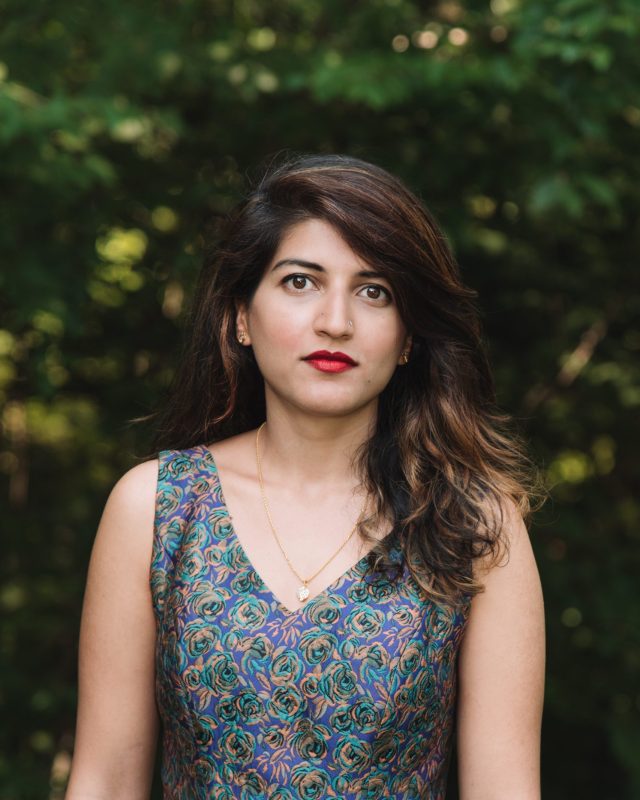 A photo of Dur e Aziz Amna in front of a green background.
